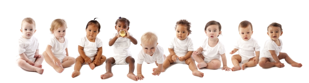 Nine diverse baby's wearing white onesies.